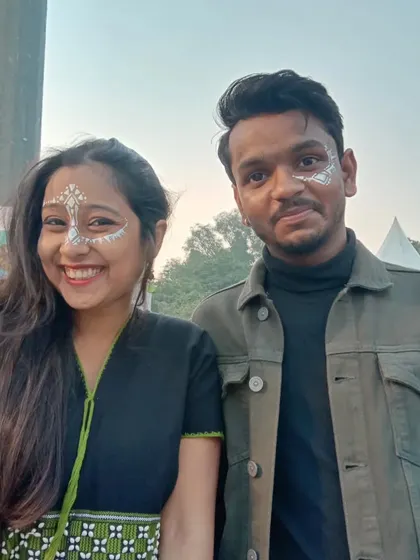 Matching white abstract face paint for a couple. This tribal-inspired look is bold and artistic.
