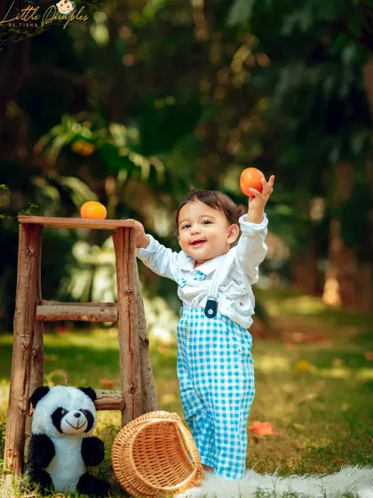 A playful moment during an outdoor picnic session with some furry friends. The natural light and setting are perfect for candid shots.