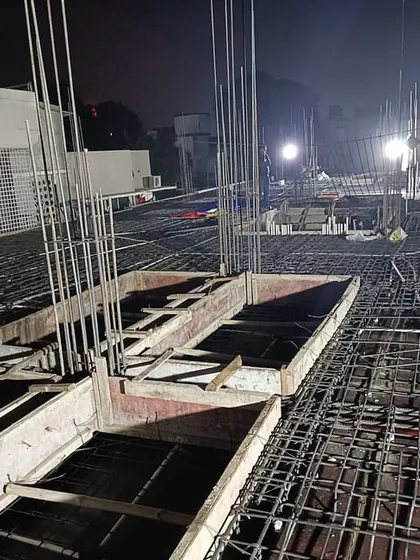 A night shot of slab preparation. Construction work often continues after dark to meet project timelines, showing the dedication involved in every build.
