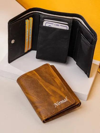 The Unisex 3-Fold Wallet is a compact and practical option. It features a coin pocket, multiple card slots, and can be personalized with an embroidered name.