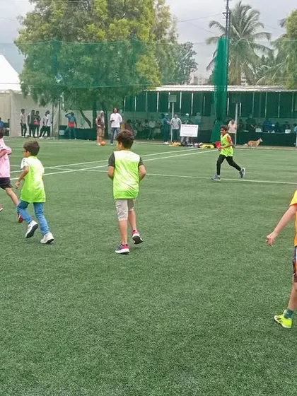 The thrill of the game! Kids chasing the ball with enthusiasm at a football-themed birthday celebration.