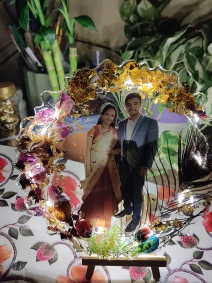 The finished resin photo frame, complete with fairy lights that add a magical glow. It comes with a small wooden easel, making it ready to display on any desk or shelf.