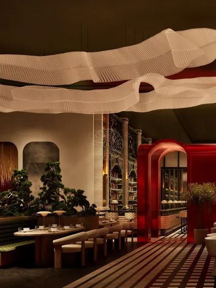 This render shows the flow from the main dining area towards the red tunnel, with the origami light installation guiding the eye through the space.