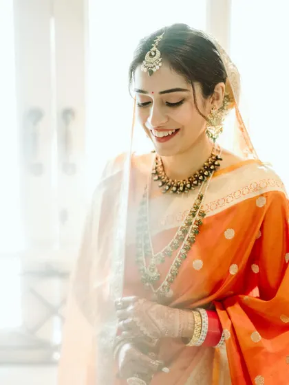 A candid and joyful portrait. The natural light highlights her glowing skin and the soft, minimal makeup.