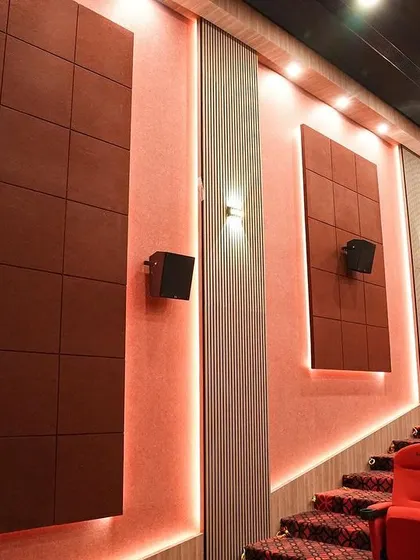 This shot highlights the acoustic wall panels and the surround sound speakers, which are crucial for creating an immersive Dolby audio experience in a room of this size.