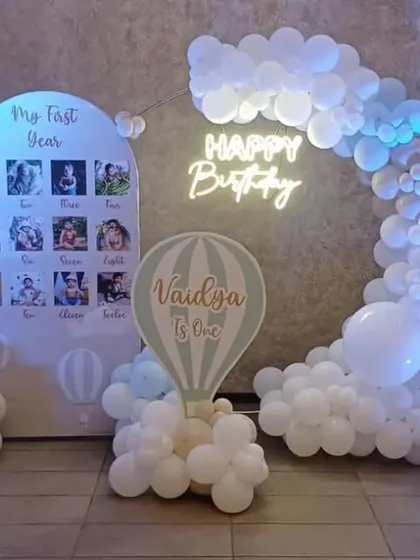A 'My First Year' photo board as part of a hot air balloon-themed party. It's a wonderful way for guests to see how much the little one has grown.