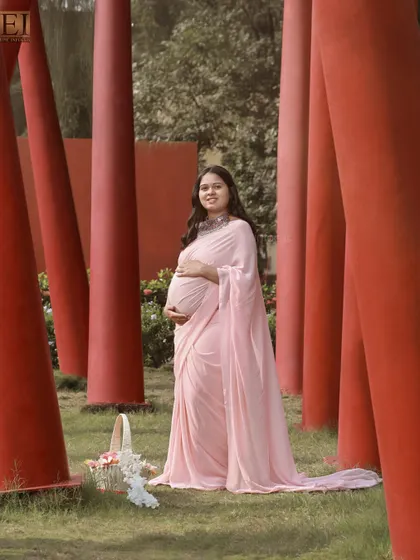 Another angle of the pink saree shoot, showing how the flowing fabric creates a graceful silhouette.