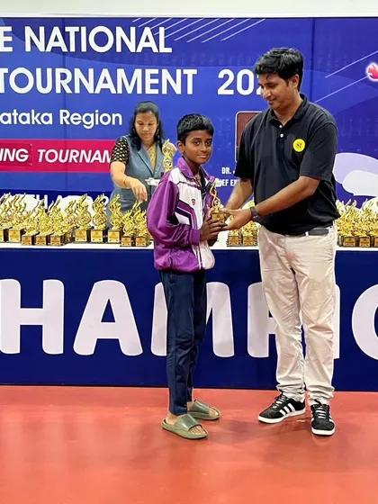 Recognizing emerging talent is key to our mission. A young competitor is awarded his trophy at the national tournament.