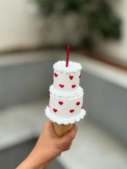 Another version of my ice cream cone cake, this one with tiny red hearts. It's a whimsical and fun treat for any celebration.