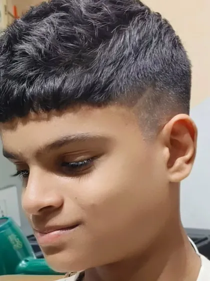 A modern crop haircut with a fade for a stylish young client.