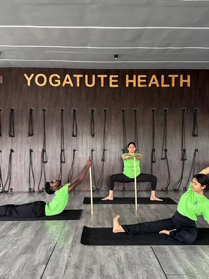 A powerful image showcasing stick yoga, with students demonstrating various poses that highlight the prop's versatility for strength, alignment, and flexibility.