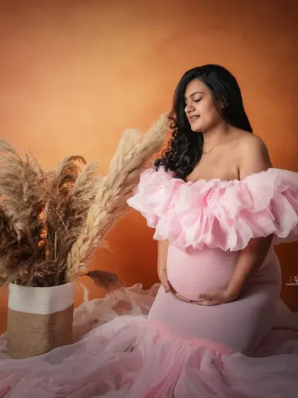 A lovely portrait in a pink ruffled gown against a warm, earthy backdrop. This image shows the versatility of studio sessions, easily switching from dramatic to soft and sweet.