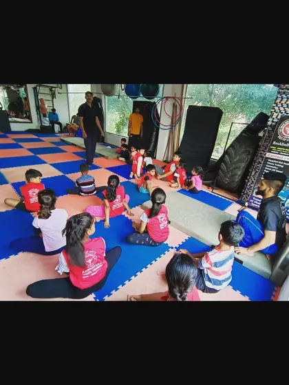 A quiet moment during class where students are seated and listening to instructions. Discipline and focus are just as important as physical skill.