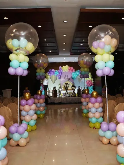 A "balloon blast" entry is a fun way to welcome guests. I created this walkway with colorful balloon pillars topped with large confetti-filled balloons for a festive and exciting entrance.