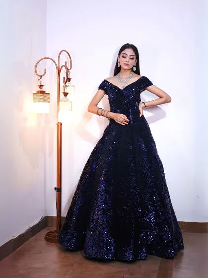 Another full-length shot of the blue sequin gown, showing its impressive volume and sparkle.