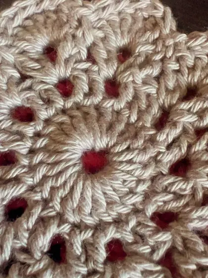 A close-up view of the detailed stitch work in a two-tone mandala coaster. The texture and pattern are what make these little pieces of art so special.