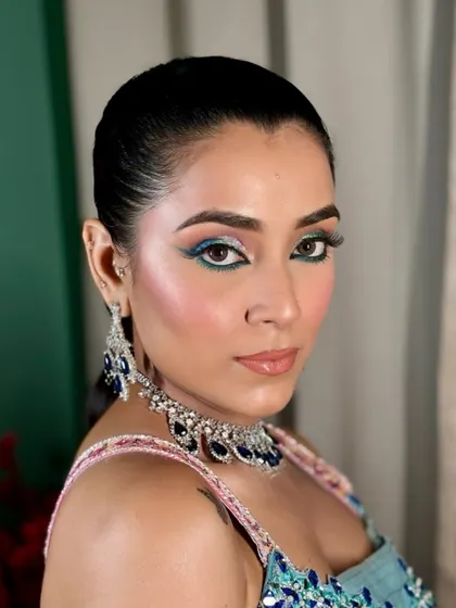 A still from the modern Mehendi glam shoot. The combination of pink blush and blue eyeliner is playful and perfect for a festive, daytime look.