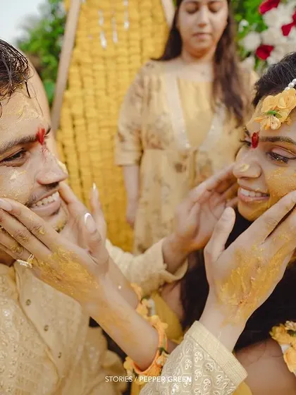 A playful moment during Medhus and Adi's Haldi, as they lovingly apply turmeric to each other's faces. These are the fun, candid memories that make a wedding film special.