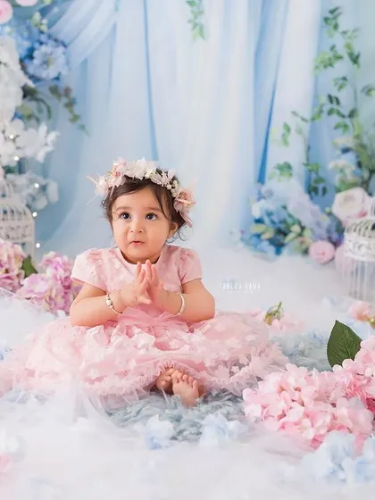 A moment of quiet contemplation for this little girl, sitting among a sea of pink and blue flowers.