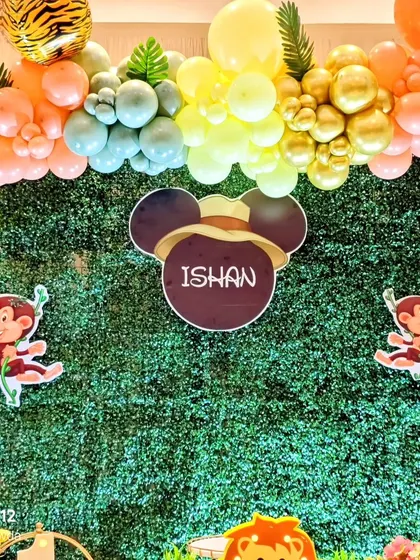 A personalized name sign with a Mickey Mouse safari theme, set against a vibrant green hedge backdrop. This shows how I can combine a classic character with a popular theme like the jungle.