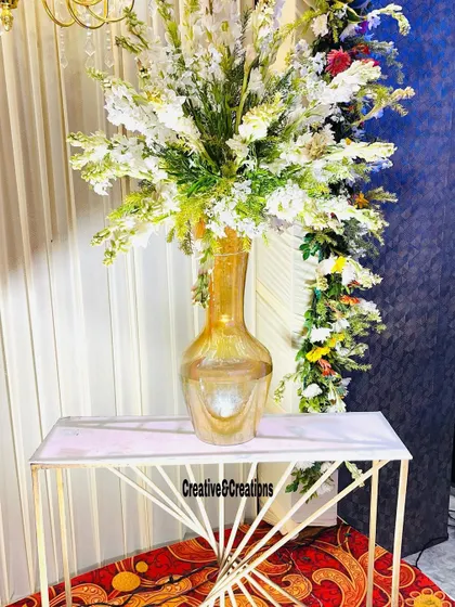 A close-up of a beautiful floral arrangement in a glass vase, perfect for adding a touch of elegance to guest tables at a daytime event.
