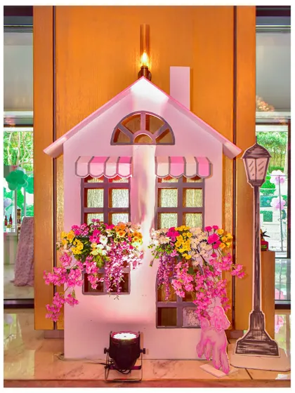 A charming Parisian house facade prop, with flower boxes overflowing with colourful blooms, adding to the romantic city theme.