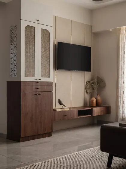 This entertainment zone combines functionality with style. The floating TV console provides storage without taking up floor space, and the combination of wood, rattan, and textured wall panels adds warmth and visual interest.
