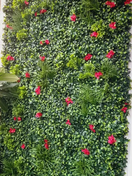 The finished artificial vertical garden, looking lush and full. I mix different types of artificial leaves and add colorful flowers to make it look more dynamic and real.