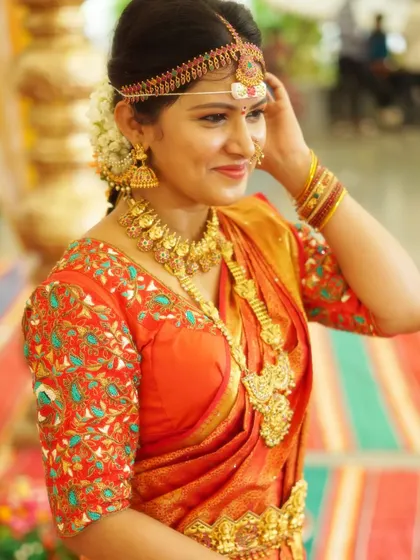 Another angle showing the beautiful temple jewellery set. The matching headband and nose ring complete this traditional South Indian bridal ensemble.