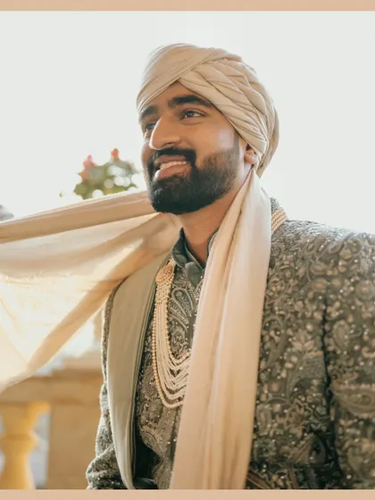 A sun-kissed portrait of the groom, Ritesh. The golden light and his happy expression perfectly capture the joy of his wedding day.