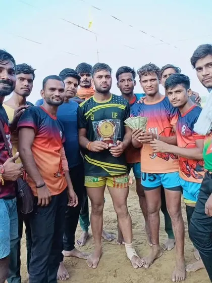 The team with their trophy and prize money after winning a tournament in Etah.