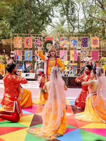 Another angle of the Radha-Krishna performance, showcasing the vibrant costumes and the unique stage backdrop.
