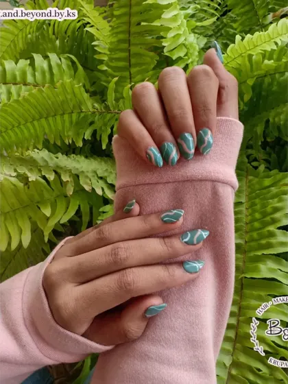 Another look at these beautiful teal swirl nails, showing how the pattern flows across each nail for a cohesive and artistic design.