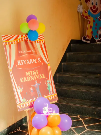 A personalized welcome sign at the entrance sets the stage for a themed event. This sign for 'Kiyaan's Mini Carnival' immediately introduced guests to the fun and excitement that awaited them inside.