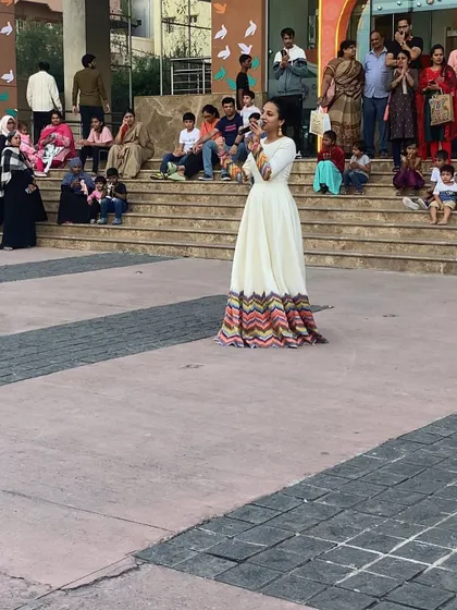 Nisarga engaging with the crowd, showing how comfortable and eye-catching our rental gowns are for active events.