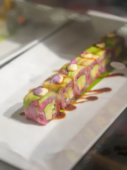 A duplicate of image 134, showcasing our visually striking pink and green sushi rolls. Our chefs love to play with colour to create food that is as exciting to look at as it is to eat.