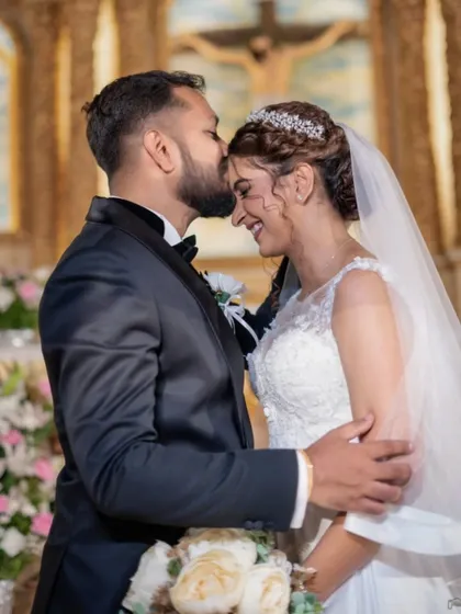 A tender kiss on the forehead at the altar. A beautiful, emotional moment from their wedding ceremony.
