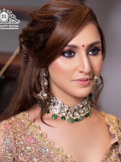 A close-up of a bold and beautiful look. This features a dark smokey eye and a nude lip, paired with traditional jewellery for a fusion style perfect for a reception.