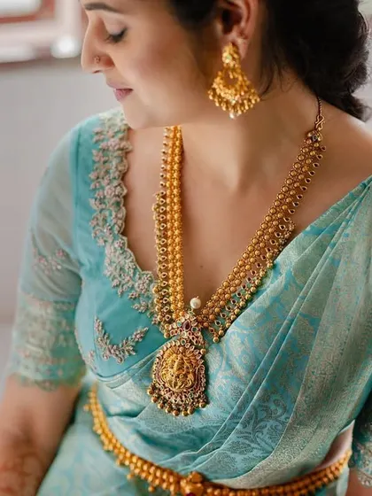 A close-up detail shot of the bride's makeup and jewellery. The focus is on the soft, blended eyeshadow and the perfect base that looks like real skin.