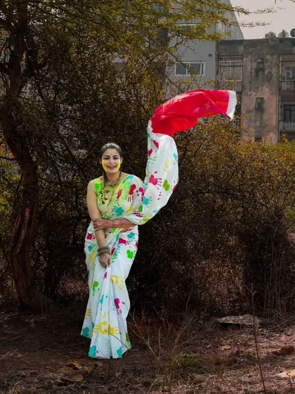 Capturing the beautiful drape of the saree as it catches the wind. This shot from the Holi series is full of movement and grace, highlighting the festive outfit in a natural setting.
