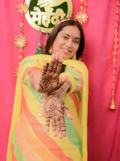 Another joyful shot of the bride at her mehandi function. Our designs are made to be photographed and become a beautiful part of your wedding album.