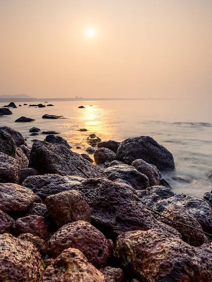 A long exposure shot of a rocky sunrise in South Goa. Photography is less about what your eyes see, and more about what your soul feels.