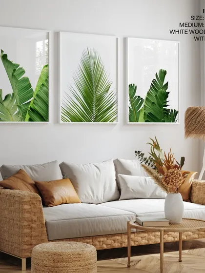 Our set of three botanical prints, framed in crisp white wood, adds a touch of nature to this living room decorated with rattan and other natural materials. The look is fresh, clean, and inviting.