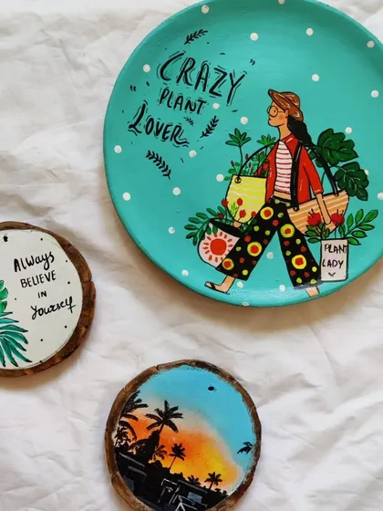 A collection of our hand-painted decorative plates and wooden slices. This "Crazy Plant Lover" plate is a fun and colorful piece for any plant enthusiast's home.