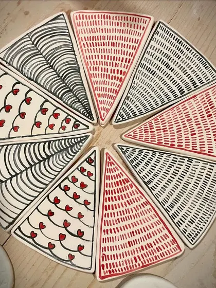 These hand-painted triangular plates were part of a special collection. I love experimenting with geometric patterns and playful designs like these hearts and lines.