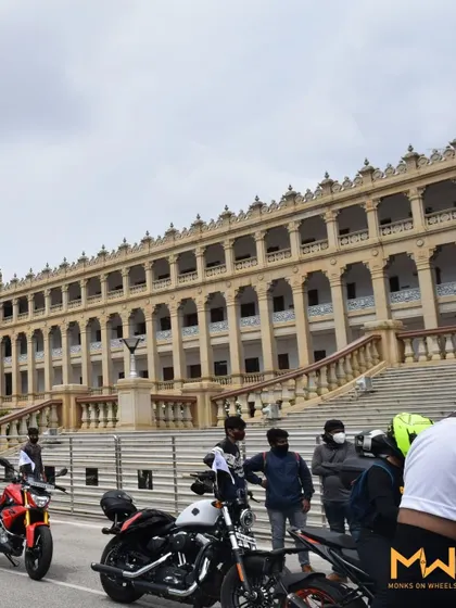 Riders and their bikes with the impressive architecture of a government building as a backdrop.