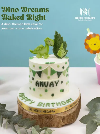 Dino dreams baked right! This roar-some dinosaur-themed cake for Anvay features a friendly green dino and leafy decorations.