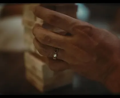 A close-up detail from the Tanishq 'A Soulmate Story' campaign. The focus here is on the elegant 'Soulmate Diamond Pair' ring, styled to look natural and effortless as part of a quiet, intimate moment at home.