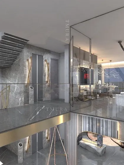 This duplex living area is connected by a floating staircase, creating a visual link between two levels. We used polished marble flooring and reflective surfaces to enhance the sense of space and light, crafting a cohesive and luxurious environment.