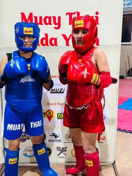 Two of our female fighters geared up and ready for a sparring session. We provide a safe and empowering environment for women to train and compete.